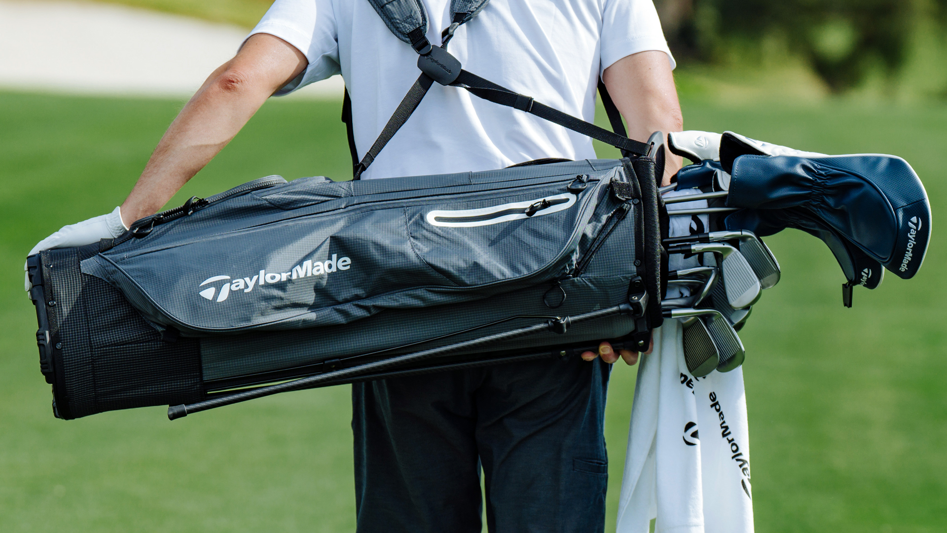 golfer walking the golf course with a golf bag on their back - Titleist golf bag
