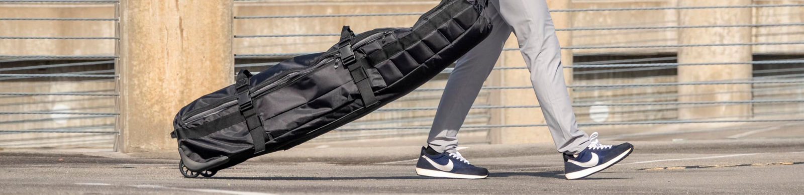 Golfer traveling with a golf bag travel cover